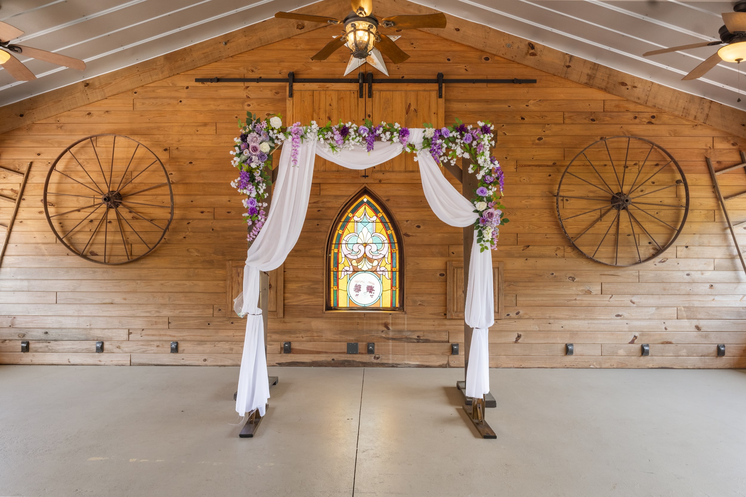 Rustic ceremony arch decorated for barn wedding