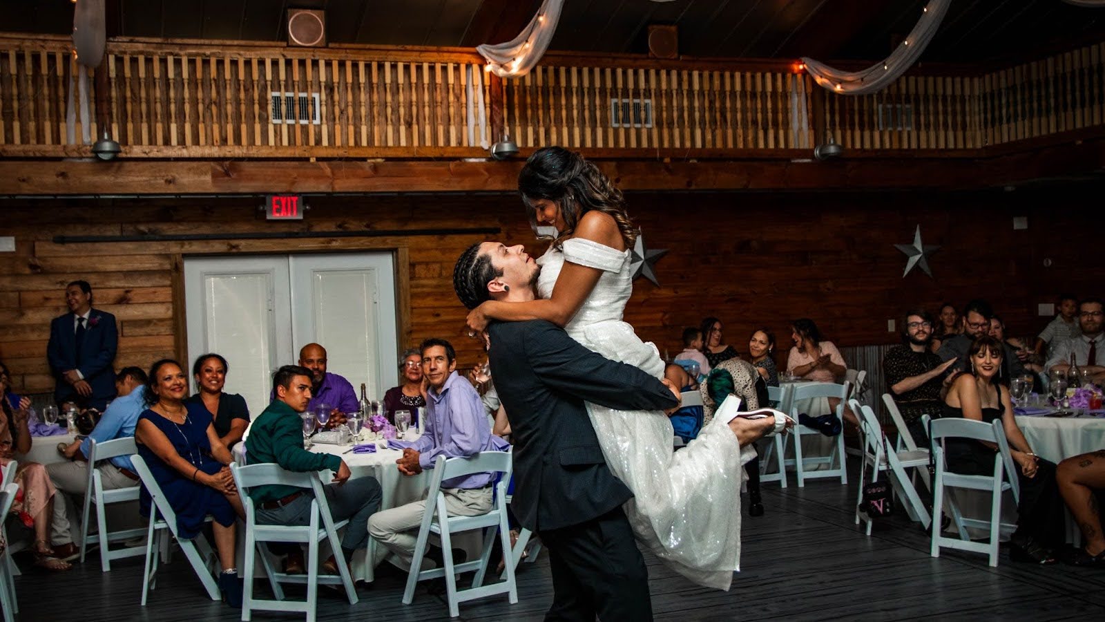 beautiful newlyweds kiss in barn at hidden barn venue florida