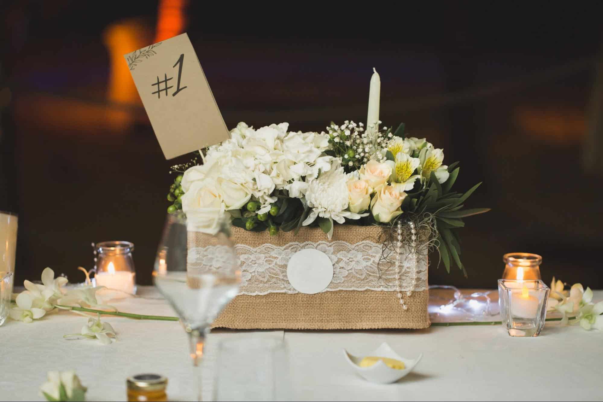 Burlap box as wedding centerpiece with florals and table number