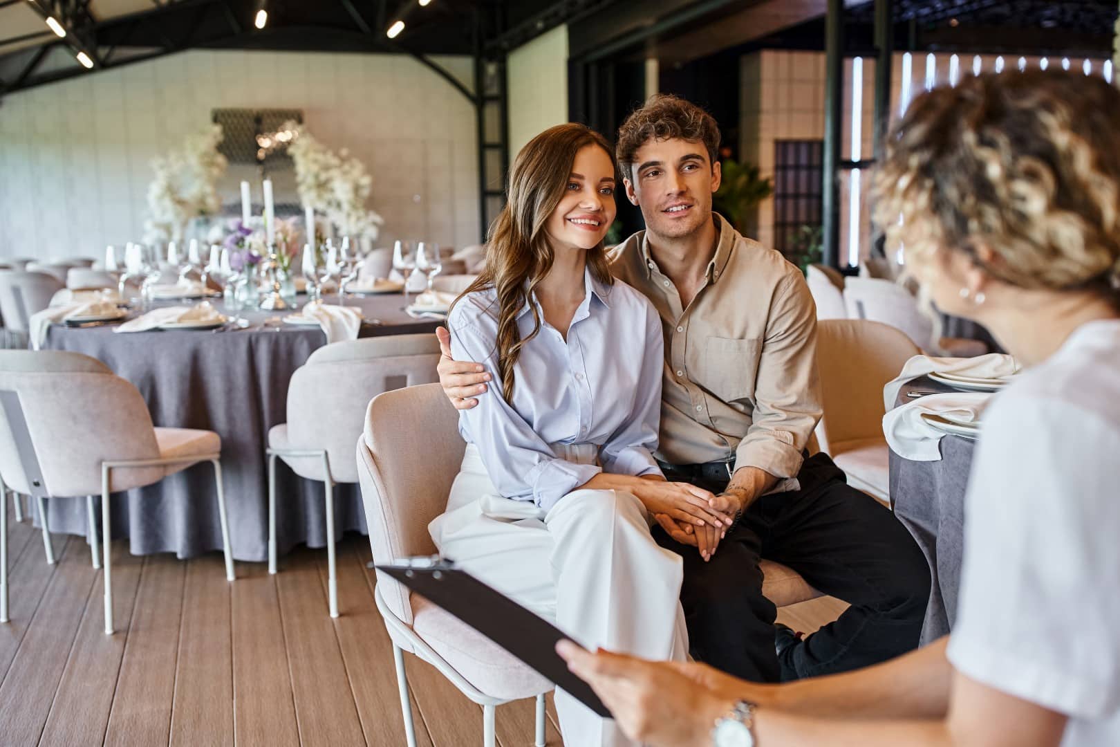 engaged couple talking to wedding venue coordinator